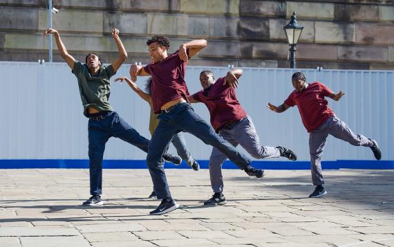 A performance group dancing with high energy