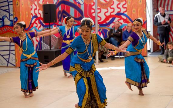 Swati Dance Company ladies in blue saris dancing gracefully