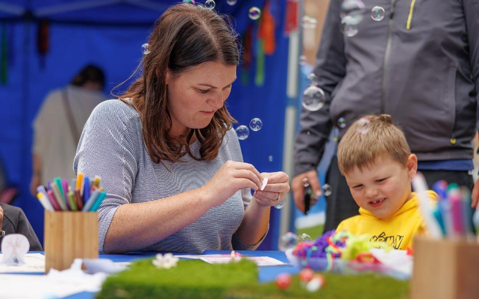 A mum and son doing arts and craft activities.