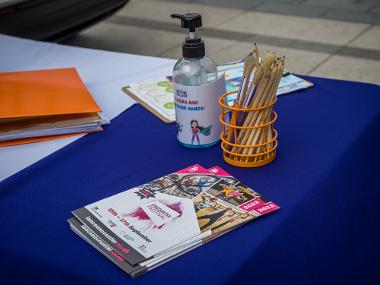 A table with pencils, hand gel and an Encounter guide book.