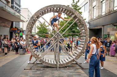 A look inside the wooden wheel where a performer is climbing in and out