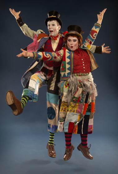 Two performers for Betty Brown Bags pose mid jump for a photo