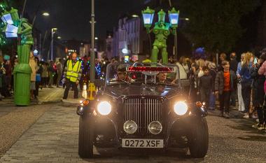 A couple in a car in the encounter parade