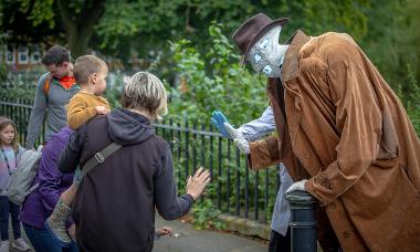 The invisible man giving a high five to a family at the Encounter Festival 2024