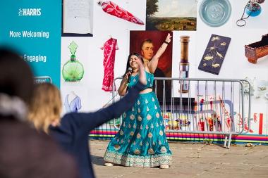 A lady performing at the 2024 Encounter Festival dancing on the Flag Market.