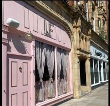 A restaurant with a pink front