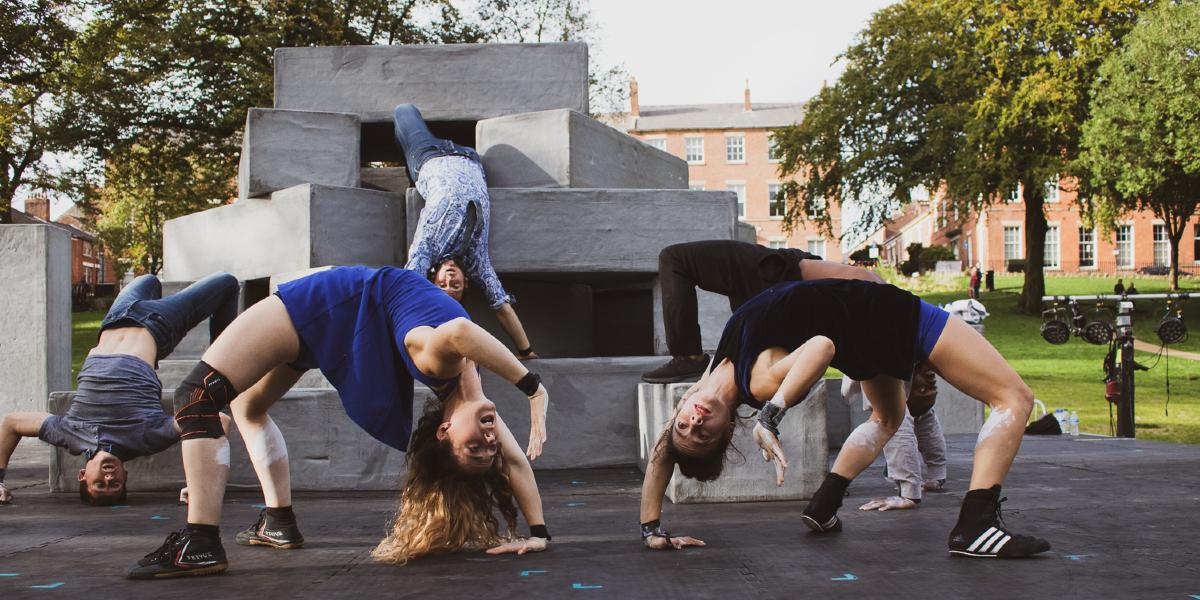 Main image: Block doing the crab The artist block doing a gymnastic move whilst upside down.