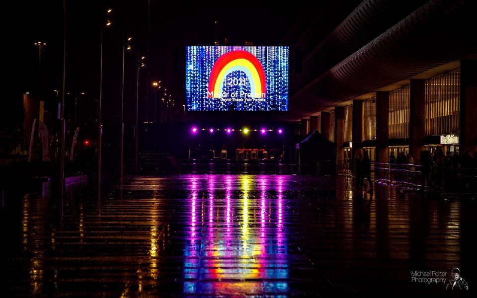 The Mayor of Preston Covid Parade on a big screen next to the bus station